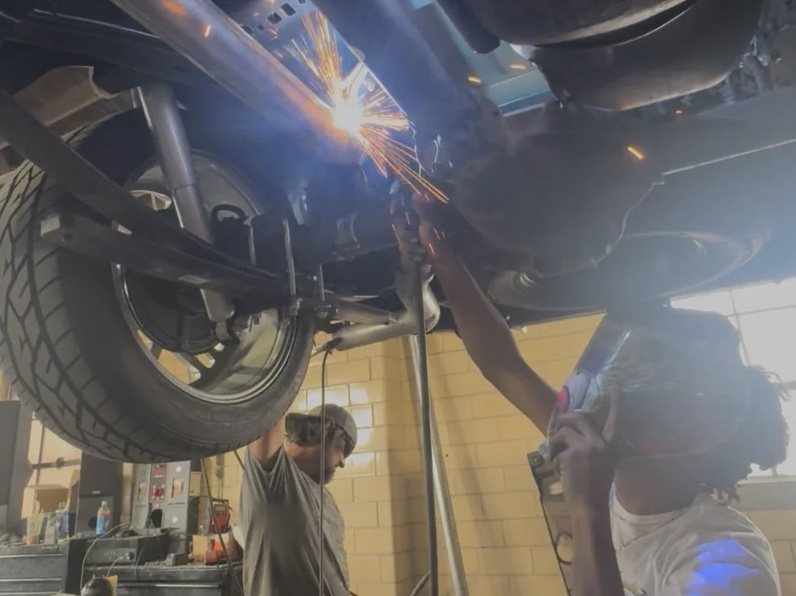 Poppy's team welding custom exhaust in the shop